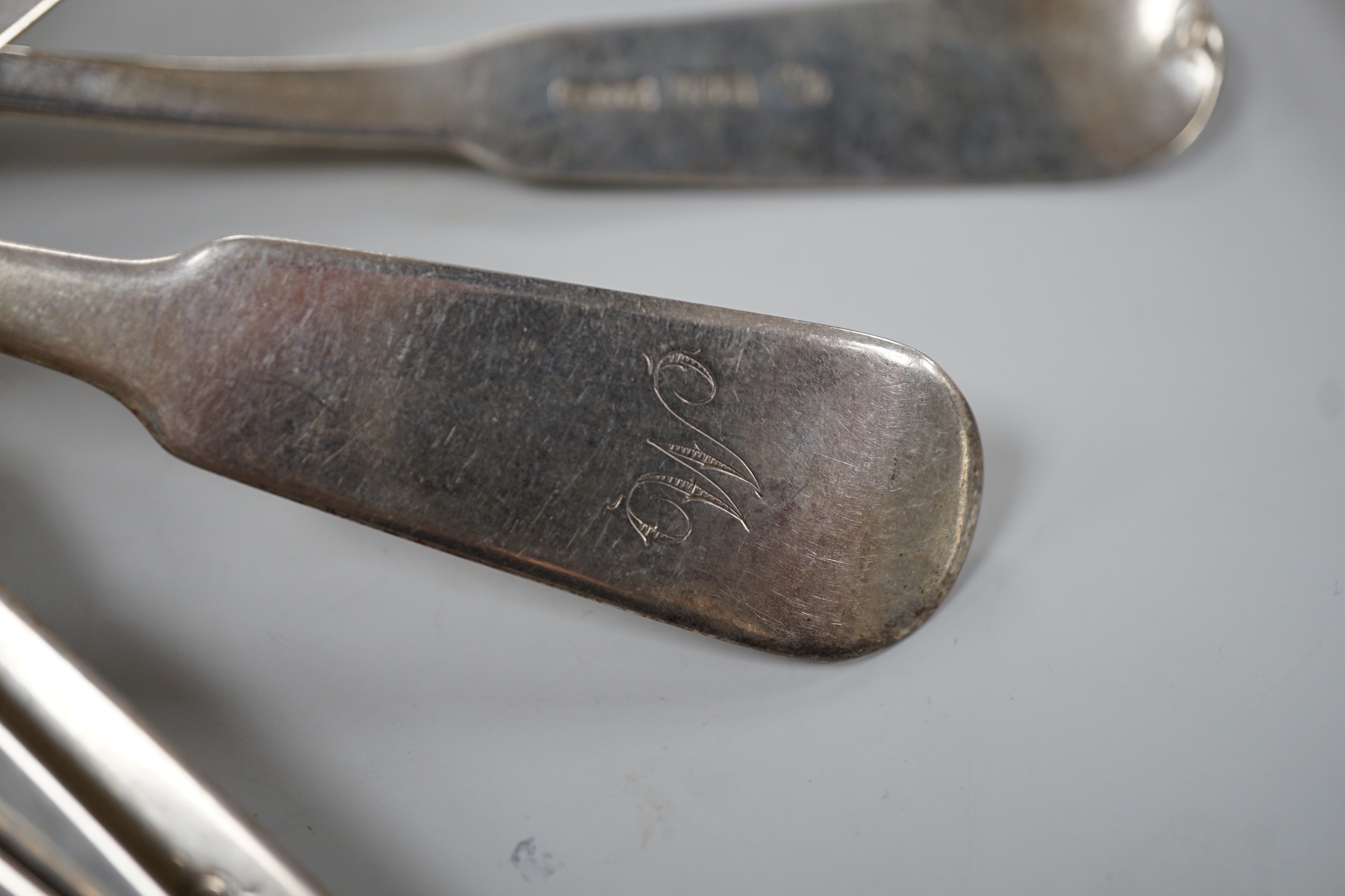 A set of nine early 19th century Scottish provincial silver fiddle pattern dessert spoons, 18.5cm and a pair of sauce ladles, by Alex MacLeod, Inverness, 11oz.
